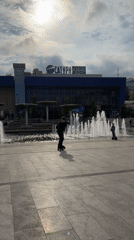 Brass band performs in Yalta square, draws dancer and skater