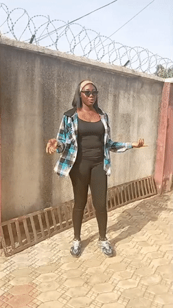 Woman photographed in courtyard in Rido, Nigeria