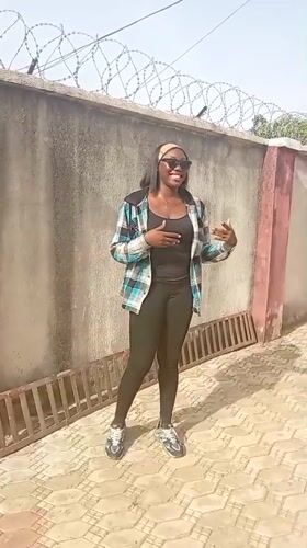 Woman photographed in courtyard in Rido, Nigeria