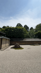 Raked gravel and mossy rocks in a Kyoto zen garden