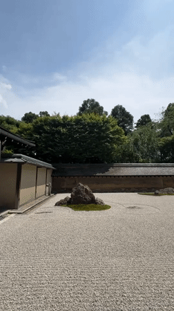 Raked gravel and mossy rocks in a Kyoto zen garden