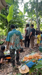 Communal gathering with open-fire cooking in tropical Indonesia