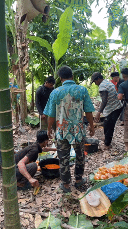 Communal gathering with open-fire cooking in tropical Indonesia