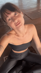Woman practices yoga, documents session in Mengwi studio