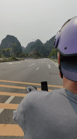 Motorcyclist travels marked road in Quang Hanh, Vietnam