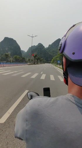 Motorcyclist travels marked road in Quang Hanh, Vietnam