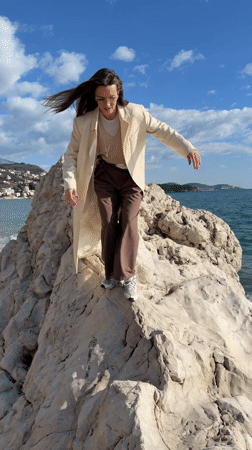 Woman enjoys seaside moment with dog on Montenegro coast