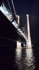 Cable-stayed bridge illuminated at night in Cherepovets, Russia