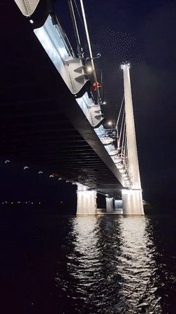 Cable-stayed bridge illuminated at night in Cherepovets, Russia
