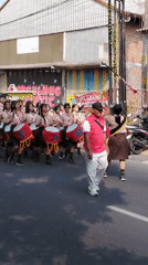 Scout drum corps marches through the streets of Magelang