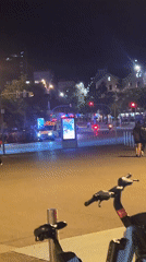 Ambulance responds through Barcelona intersection at night