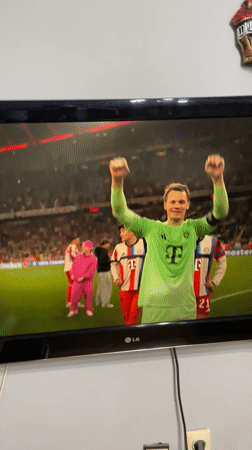 Resident records soccer match featuring Manuel Neuer on TV