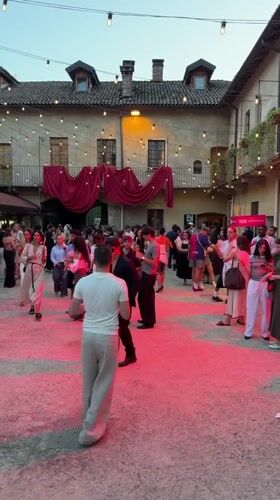 Evening courtyard event in Milan with YOOX branding
