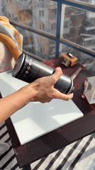 Artist spray paints canvas in Krasnoyarsk studio setting