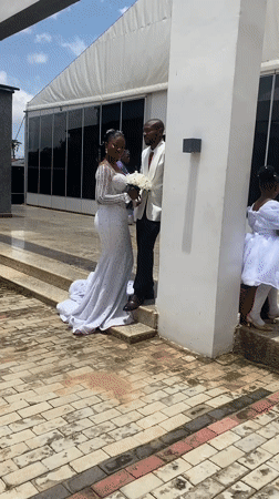 Wedding party photographs outside a modern building in Bukuru, Nigeria