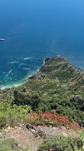 Tourist captures scenic Anacapri coastal views with Faraglioni formations