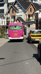 Pink tour bus departs Đà Lạt road