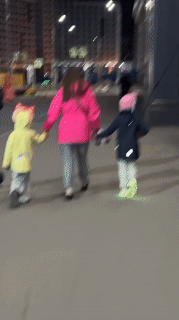 Family shares evening snack during nighttime walk in Murino