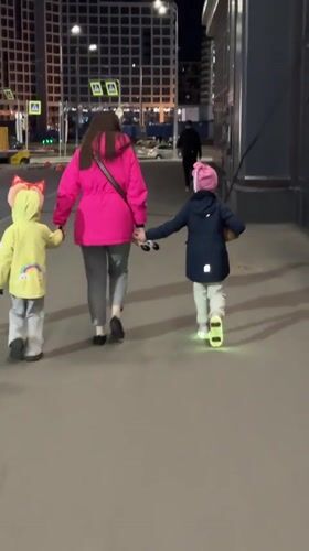 Family shares evening snack during nighttime walk in Murino