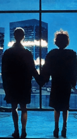 Couple holds hands at window in Mengwi, Indonesia