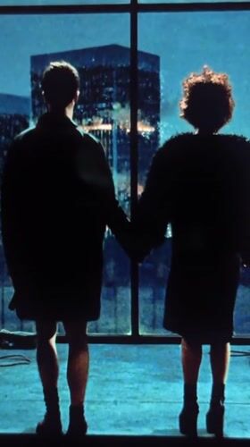 Couple holds hands at window in Mengwi, Indonesia