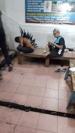 Man with spiked back attachment filmed in Denpasar