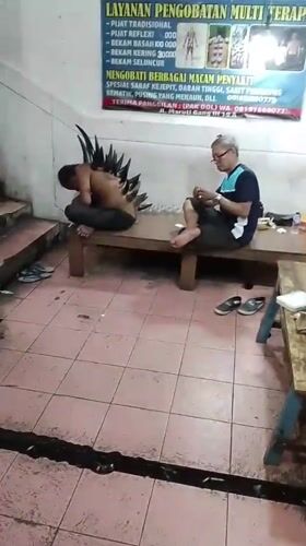 Man with spiked back attachment filmed in Denpasar