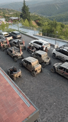Off-road vehicles gather on cobblestone streets in Sighnaghi, Georgia