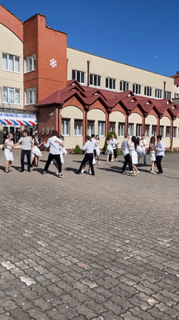 School gathering with dancing couples captured in Zelenogradsk