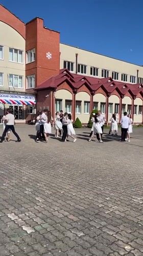 School gathering with dancing couples captured in Zelenogradsk