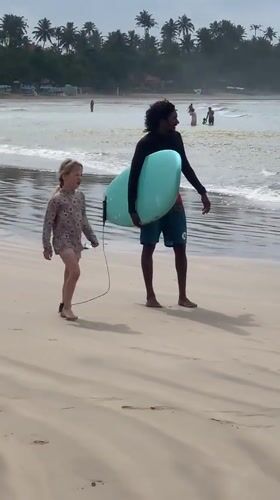 Early morning surf session draws families to Weligama Beach