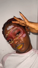 Artistic face paint session and nighttime street activity documented in Ado