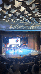 Theater performance with dancers and projected backdrop imagery