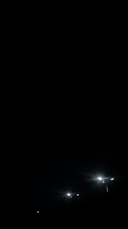 Lightning storm illuminates Jos streetscape during nighttime hours