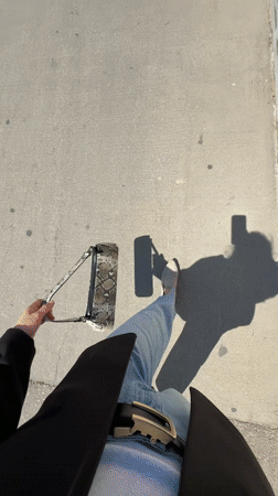 Pedestrian photographed near flower-adorned building in Tel Aviv