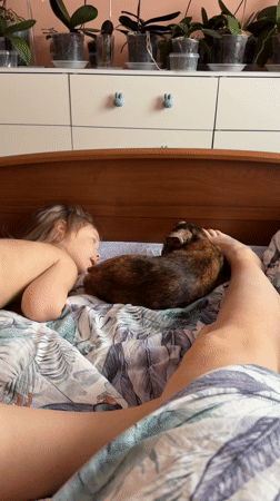 Child and cat share quiet bedroom moment in Chaikovsky