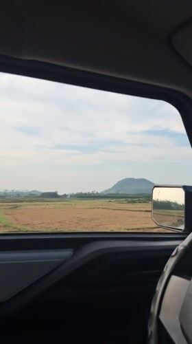 Scooter rider passes car in rural Ba Gia, Vietnam
