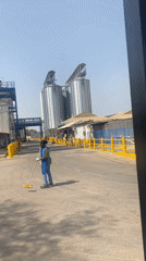 Worker sweeps industrial facility grounds in Nassarawa, Nigeria