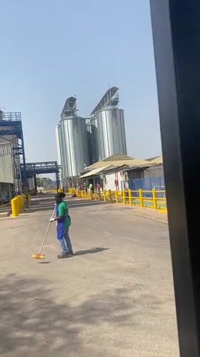 Worker sweeps industrial facility grounds in Nassarawa, Nigeria
