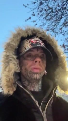 Tattooed figure in fur-lined jacket on Buenos Aires sidewalk