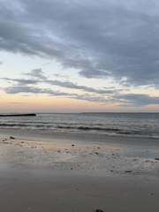 Dusk clouds and calm waves on a Dar es Salaam beach