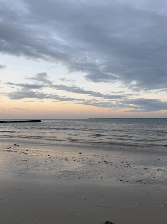 Dusk clouds and calm waves on a Dar es Salaam beach