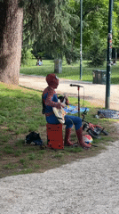 Spider-Man street performer plays guitar in Milan park