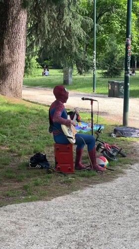 Spider-Man street performer plays guitar in Milan park
