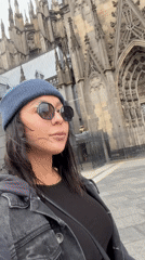 Street musicians perform at Cologne Cathedral as tourists visit