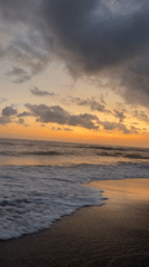 Beach sunset captured with dramatic cloudy skies and golden light