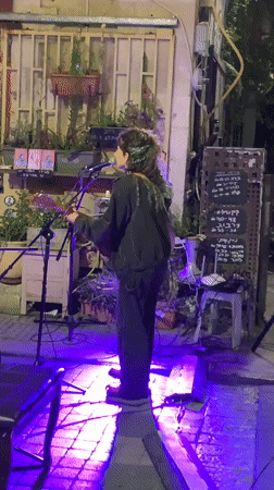 Evening street life, dining, and music captured across Tel Aviv