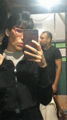 Two people take mirror selfie in Buenos Aires home