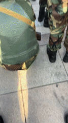 Armed soldiers in formation on a paved surface in Dushanbe