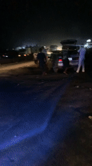 Motorcycle navigates crowded nighttime gathering in Lokoja, Nigeria